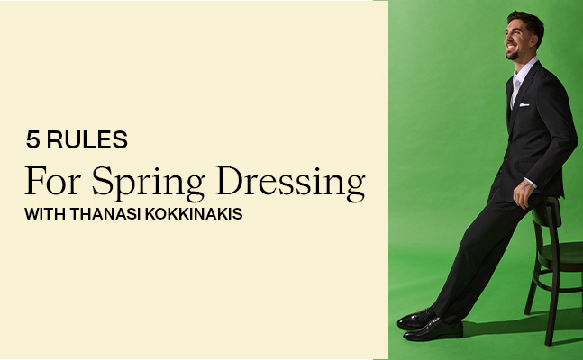 Thanasi Kokkinakis leaning casually on a chair in a tailored POLITIX suit, embodying refined spring event style for the “5 Rules for Spring Eventing”